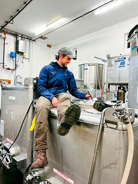 Kenny racking wine from tank to barrel