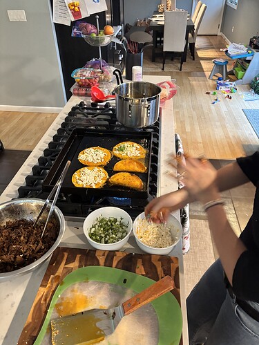Corn tortillas dunked in the oil of the consomé go on the griddle